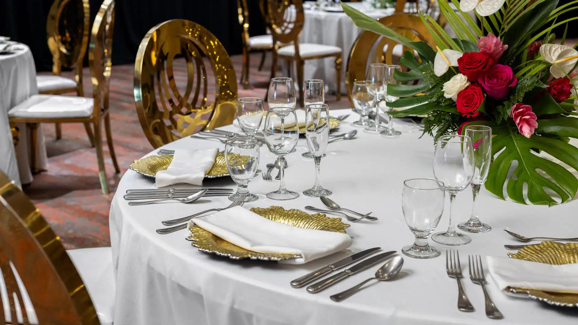 Elegant banquet table setup with floral centerpieces in the ballroom at Dreams Rose Hall Resort & Spa in Jamaica.