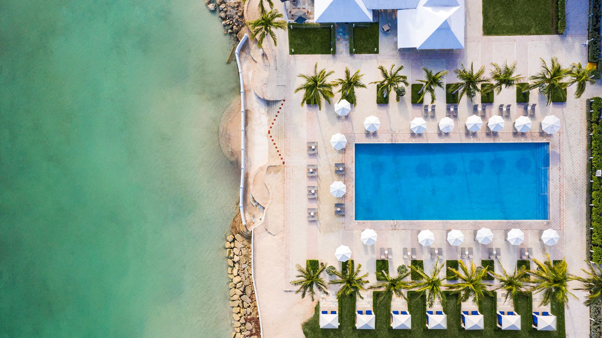 Aerial view of the beachfront pool and turquoise Caribbean waters at Dreams Rose Hall Resort & Spa in Montego Bay.