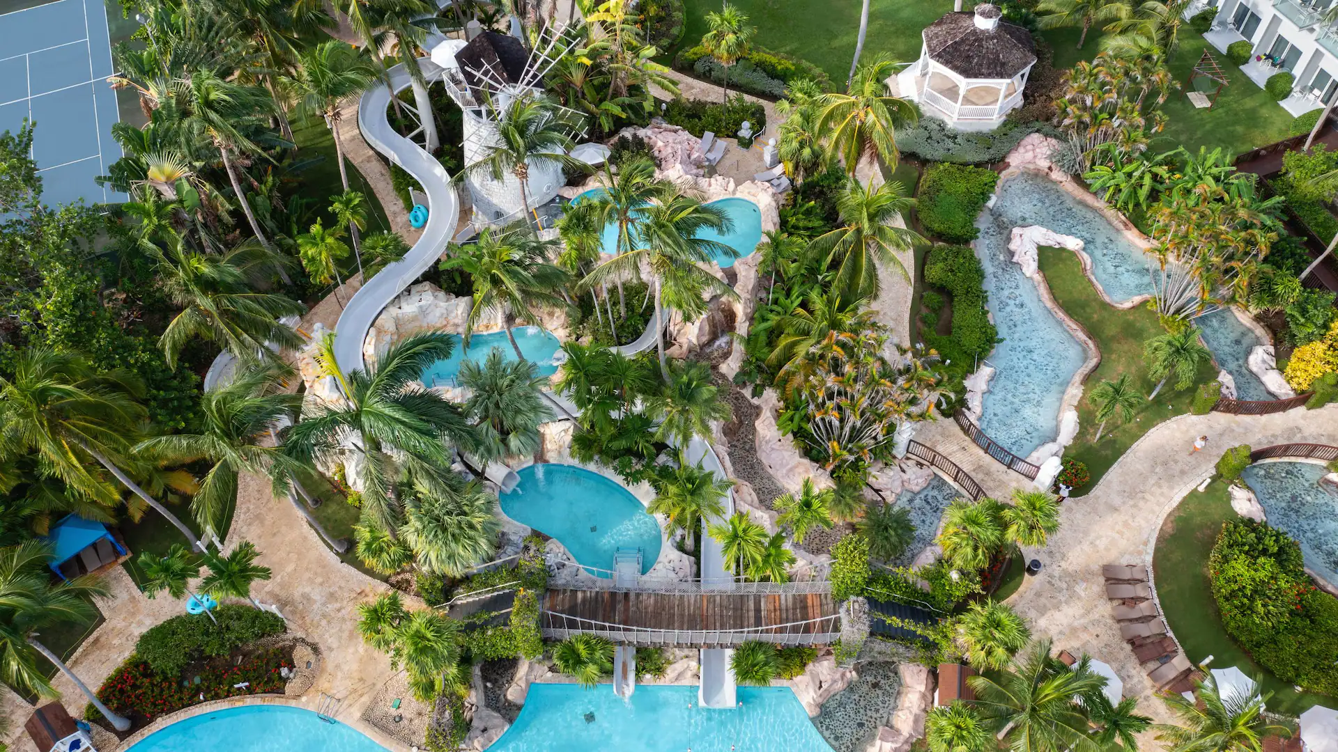 Aerial view of the lazy river and tropical waterpark area at Dreams Rose Hall Resort & Spa in Montego Bay, Jamaica.